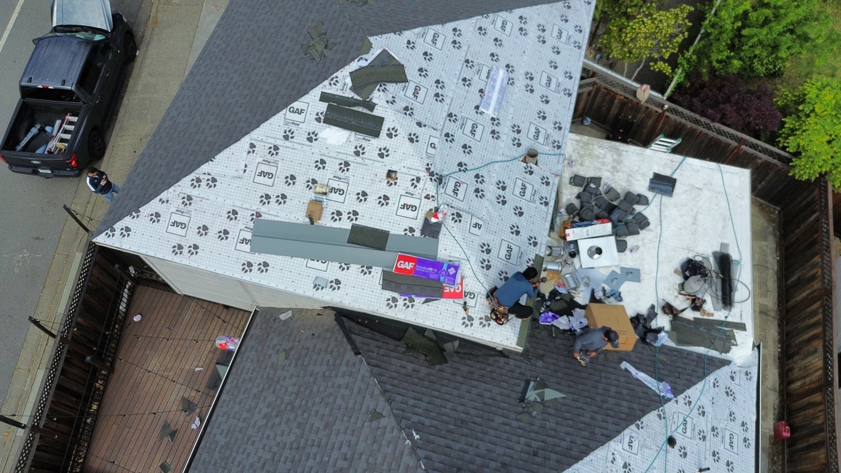 Complete roof tear-off revealing decking inspection