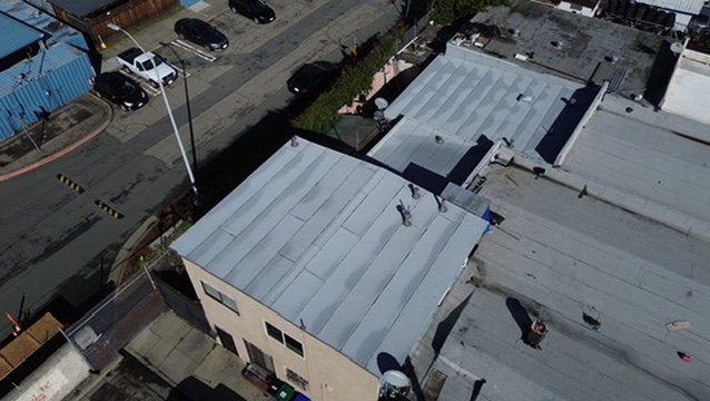 Vapor barrier and base sheet installation on flat roof